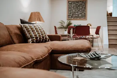 a living room with a brown couch and chairs at Modern home w hot tub & game room in Centennial
