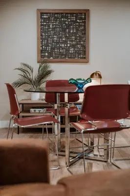 a table and chairs in a room with a board on the wall at Modern home w hot tub & game room in Centennial