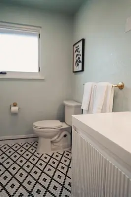a bathroom with a white toilet and a window at Modern home w hot tub & game room in Centennial