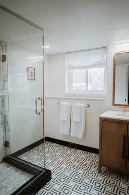 a bathroom with a glass shower and a sink at Modern home w hot tub & game room in Centennial