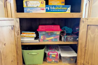 a book shelf with toys and other items on it at New Log Home, Hot Tub For 8, Views! in Tabernash