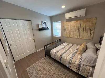 a bedroom with a bed and a white door at Chic & intimate 2 bedroom in Brighton