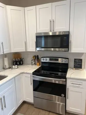 a kitchen with a stove and a microwave at Chic & intimate 2 bedroom in Brighton