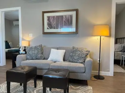 a living room with a couch and two stools at Chic & intimate 2 bedroom in Brighton