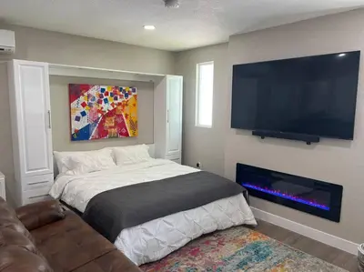 a bedroom with a bed and a flat screen tv at Modern studio in the heart of Brighton! in Brighton