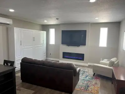 a living room with a couch and a flat screen tv at Modern studio in the heart of Brighton! in Brighton