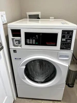 a washing machine with a microwave on top of it at Modern studio in the heart of Brighton! in Brighton