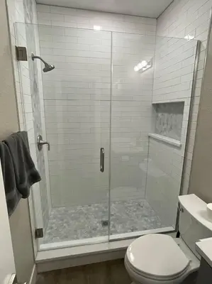 a shower with a glass door in a bathroom at Modern studio in the heart of Brighton! in Brighton