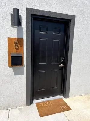 a black door with a sign in front of it at Modern studio in the heart of Brighton! in Brighton