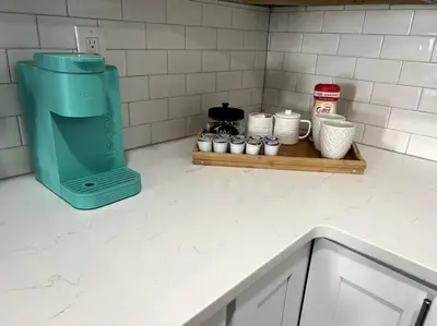 a kitchen counter with a coffee maker on a shelf at Modern studio in the heart of Brighton! in Brighton