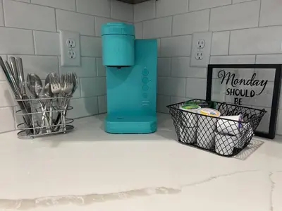 a kitchen counter with a blue water bottle and utensils at Cozy 1 bedroom in the heart of Brighton in Brighton