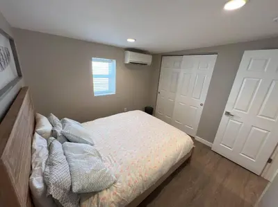 a bedroom with a bed and two white doors at Cozy 1 bedroom in the heart of Brighton in Brighton