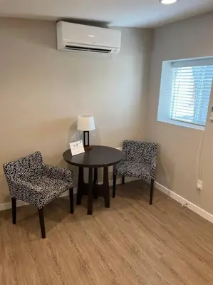 a room with a table and two chairs and a lamp at Cozy 1 bedroom in the heart of Brighton in Brighton