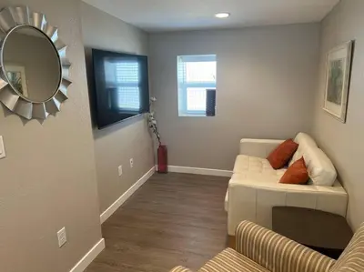 a living room with a couch and a mirror at Cozy 1 bedroom in the heart of Brighton in Brighton