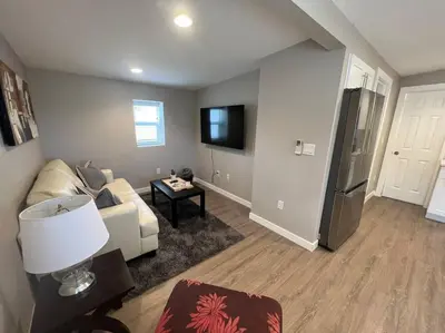 a living room with a couch and a refrigerator at Calm and relaxing 1 bed in Brighton