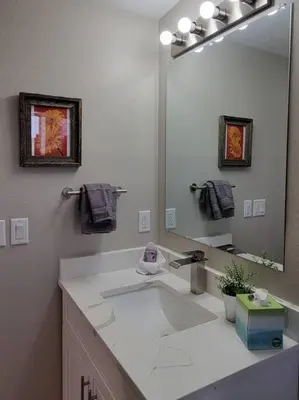 a bathroom with a sink and a large mirror at Calm and relaxing 1 bed in Brighton