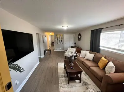 a living room with a couch and a flat screen tv at Spacious Westminster 2bd/1ba in Westminster