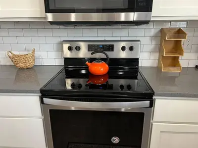 an orange tea kettle sitting on top of an oven at Peaceful 2 bed in Westminster in Westminster
