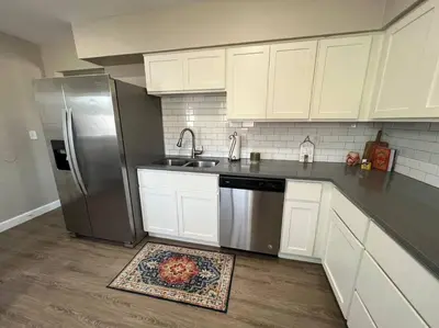 a kitchen with white cabinets and a stainless steel refrigerator at Peaceful 2 bed in Westminster in Westminster