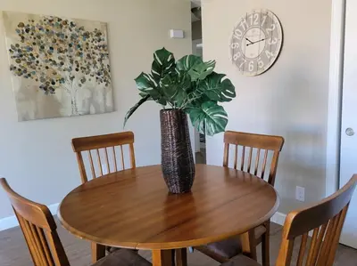 a wooden table with a vase with a plant on it at Peaceful 2 bed in Westminster in Westminster