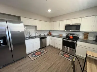 a kitchen with white cabinets and a stainless steel refrigerator at Peaceful 2 bed in Westminster in Westminster