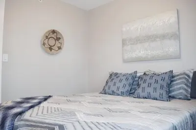 a bedroom with a bed with blue and white pillows at Cozy 3 bedroom in Westminster in Westminster