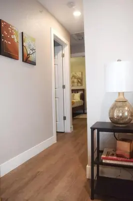 a hallway with a table with a lamp on it at Cozy 3 bedroom in Westminster in Westminster