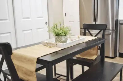 a dining room table with a plant on top of it at Cozy 3 bedroom in Westminster in Westminster