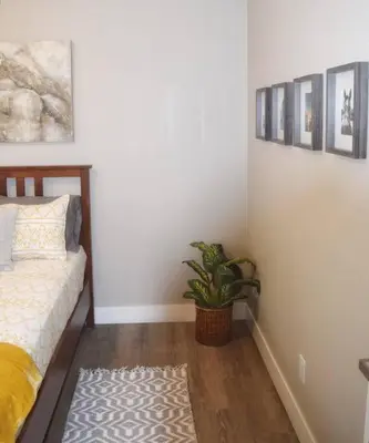a bedroom with a bed and a potted plant at Cozy 3 bedroom in Westminster in Westminster