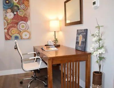 a wooden desk with a chair and a mirror at Modern 2 bed in Westminster in Westminster