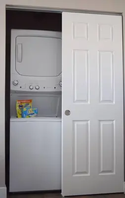 a white door leading into a refrigerator with a microwave at Modern 2 bed in Westminster in Westminster