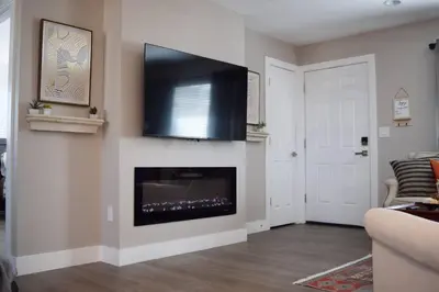 a living room with a flat screen tv above a fireplace at Modern 2 bed in Westminster in Westminster