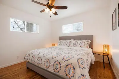 a bedroom with a bed and a ceiling fan at Cozy Getaway Retreat - 4BR - Northglenn in Northglenn