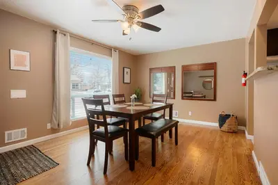 a dining room with a table and chairs and a ceiling fan at Cozy Getaway Retreat - 4BR - Northglenn in Northglenn