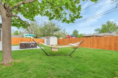 a hammock sitting in a yard next to a tree at Backyard BBQ Retreat: Central 3bd - Prime Location in Arvada