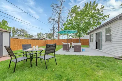 a patio with a table and chairs and an umbrella at Backyard BBQ Retreat: Central 3bd - Prime Location in Arvada