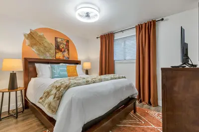 a bedroom with a large bed and a window at Backyard BBQ Retreat: Central 3bd - Prime Location in Arvada