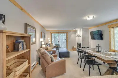 a living room and dining room with a table and chairs at Convenient Winter Park Condo - 3 Mi to Resort! in Winter Park