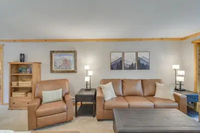 a living room with a couch and a chair at Convenient Winter Park Condo - 3 Mi to Resort! in Winter Park