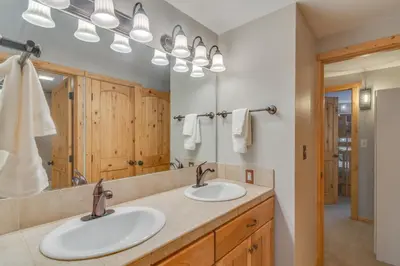 a bathroom with two sinks and a mirror at Convenient Winter Park Condo - 3 Mi to Resort! in Winter Park