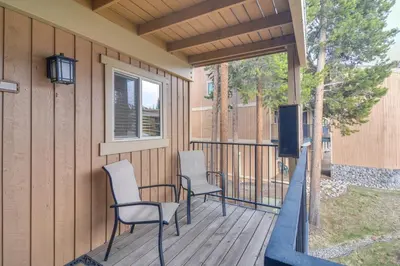 a porch with two chairs and a table and a tv at Convenient Winter Park Condo - 3 Mi to Resort! in Winter Park