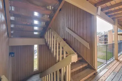a staircase in a building with wood paneling at Convenient Winter Park Condo - 3 Mi to Resort! in Winter Park