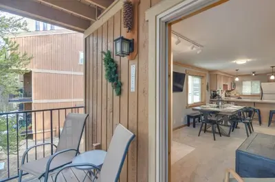 a room with a balcony with chairs and a table at Convenient Winter Park Condo - 3 Mi to Resort! in Winter Park
