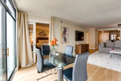 a living room with a glass table and chairs at Downtown Denver Condo in the Center of the City! in Denver