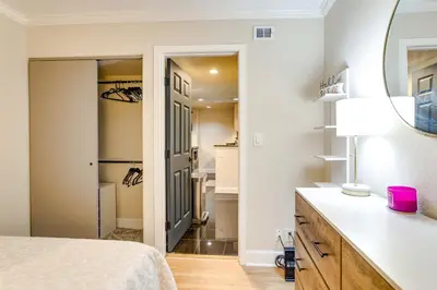 a bedroom with a bed and a sink and a mirror at Downtown Denver Condo in the Center of the City! in Denver