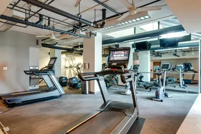 a gym with treadmills and exercise equipment in a building at Downtown Denver Condo in the Center of the City! in Denver