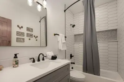 a bathroom with a sink and a toilet and a shower at Modern luxury mountain house in Fraser