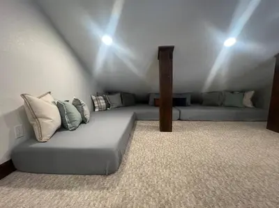 a room with a couch with pillows on it at Modern luxury mountain house in Fraser