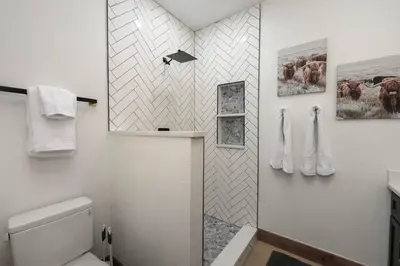 a bathroom with a shower and a toilet in it at Modern luxury mountain house in Fraser