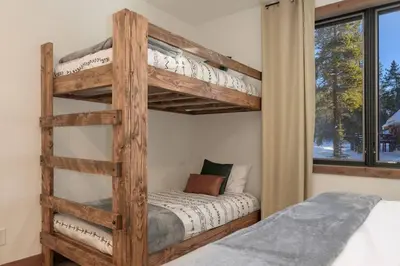 a bunk bed in a bedroom with a bunk beduteneway at Modern luxury mountain house in Fraser